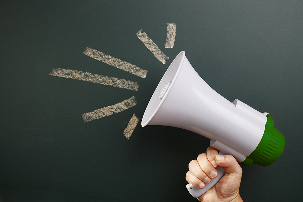 Image of a person holding a megaphone making a public call for nominations