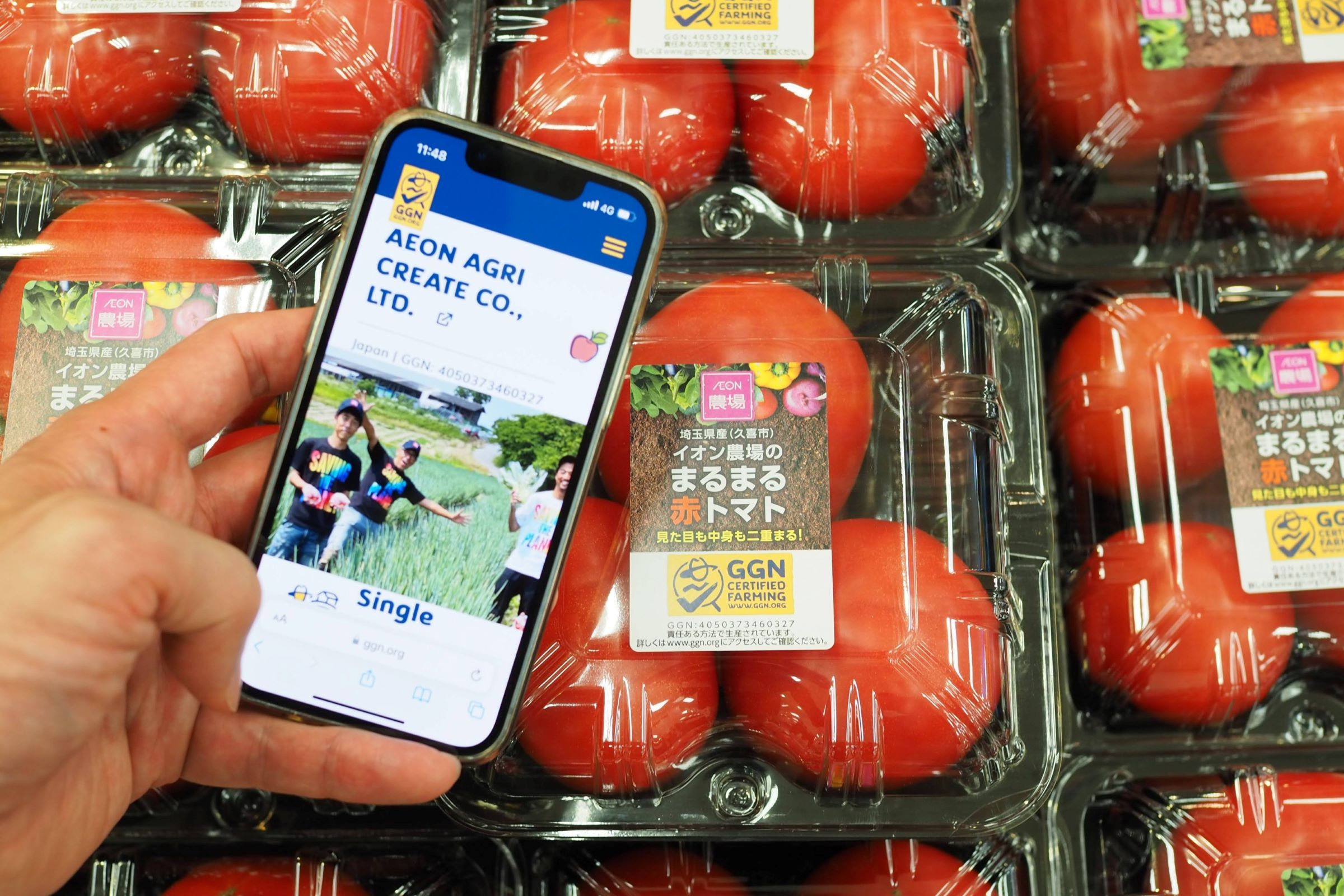 Photo of a consumer reading a GGN label farm profile in a Japanese supermarket.
