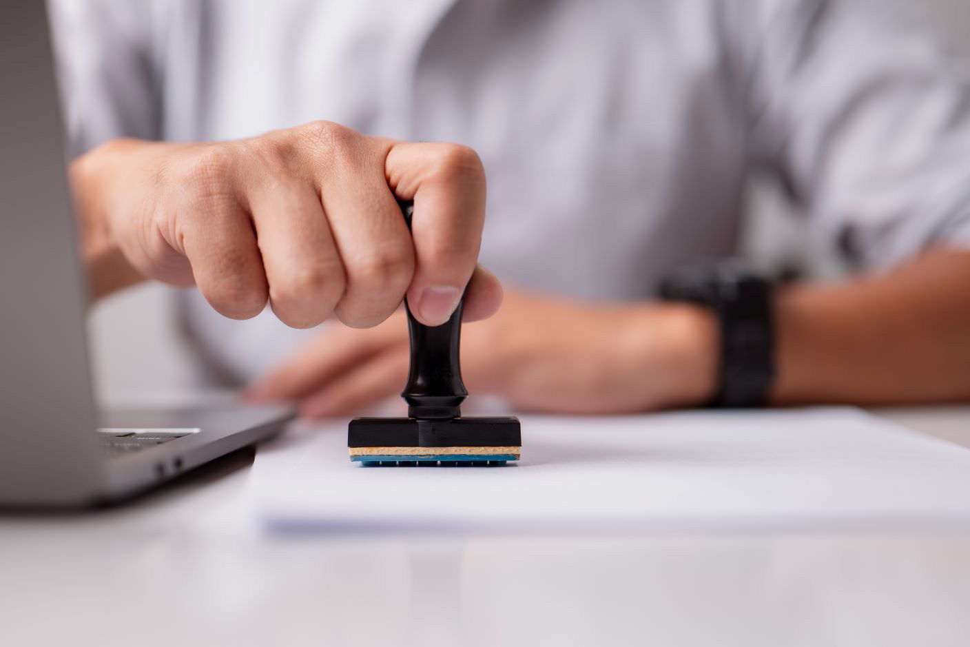 Close-up of a hand stamping a document
