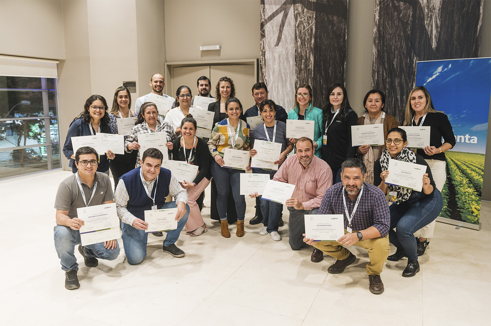 Image of participants holding certificates at the end of a private training course