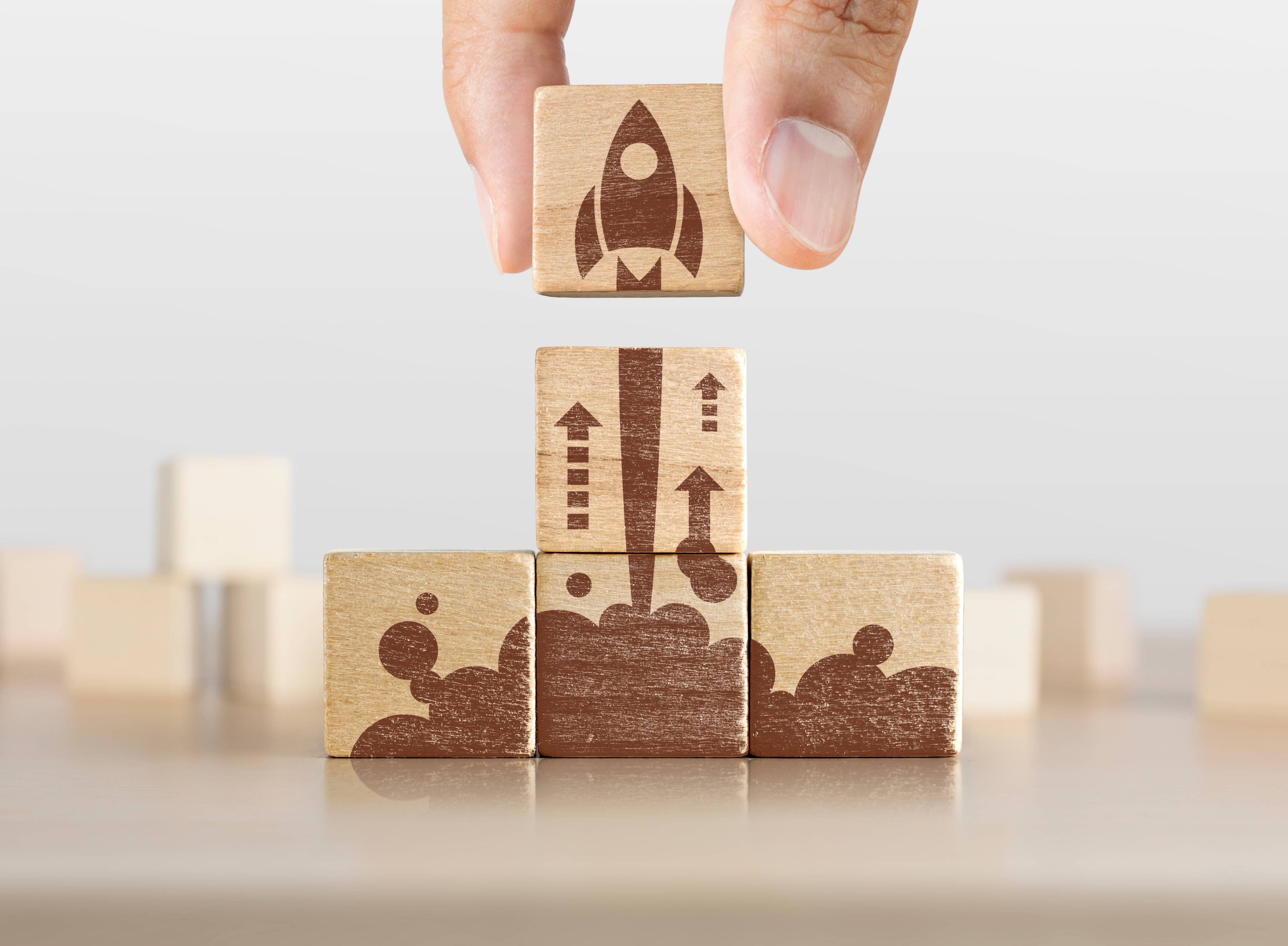 Image of wooden blocks with a rocket design assembled to represent a product launch