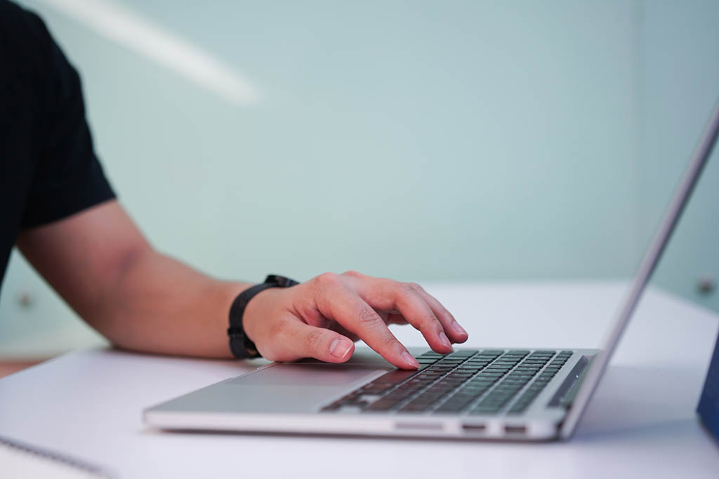 Image of a person submitting an online application