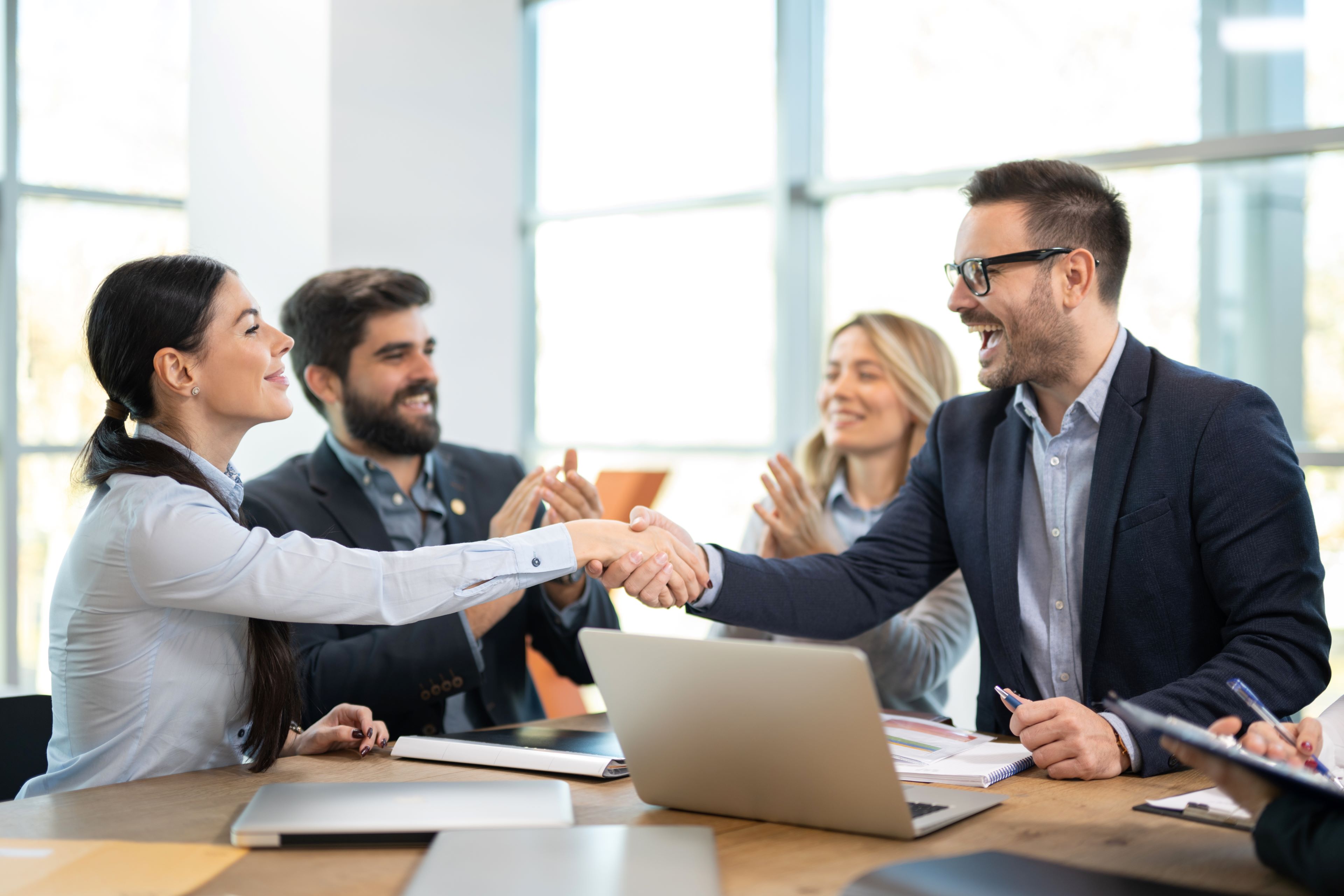 Image of two team members shaking hands
