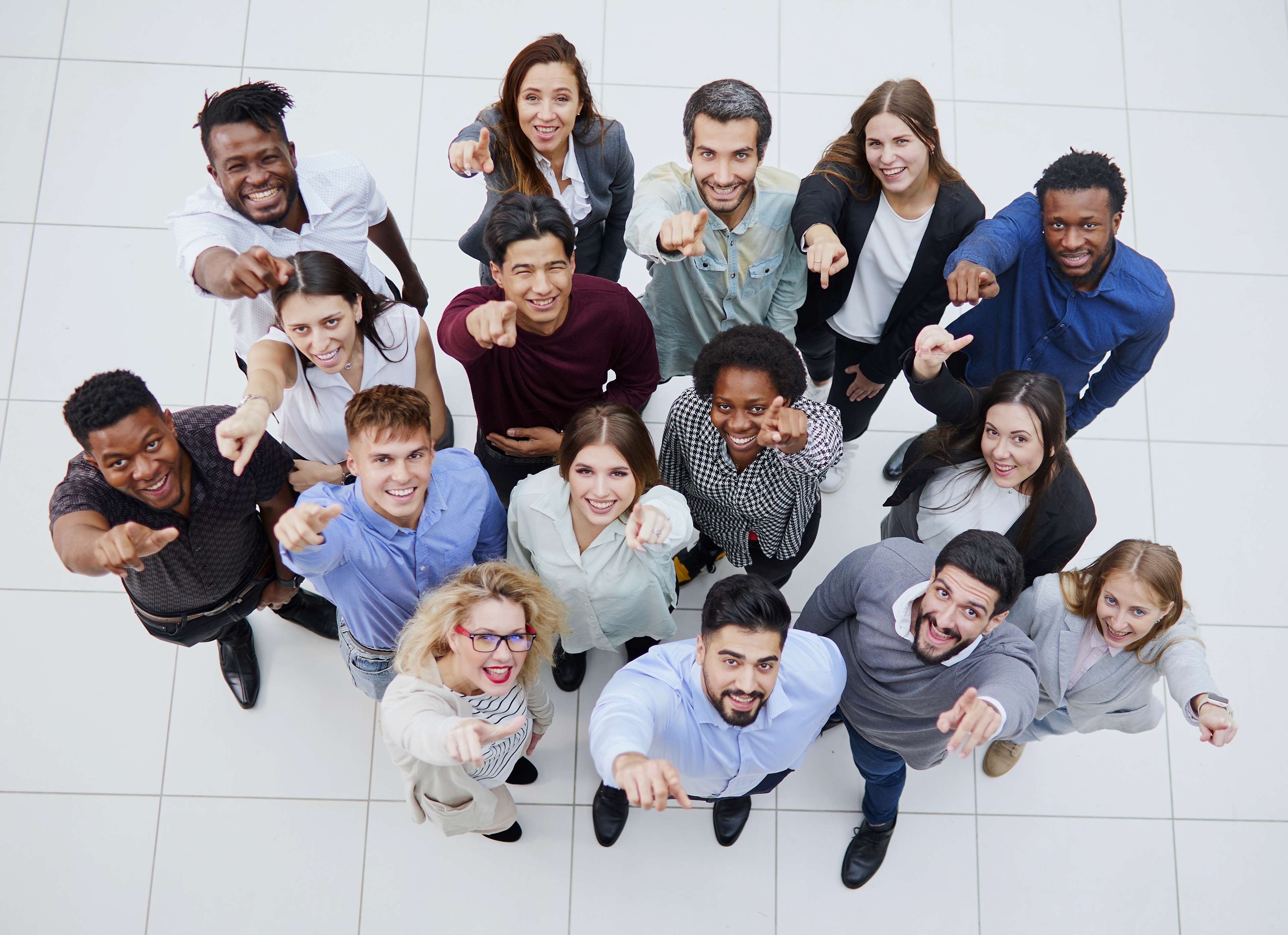 Image of a group of employees pointing up at the camera