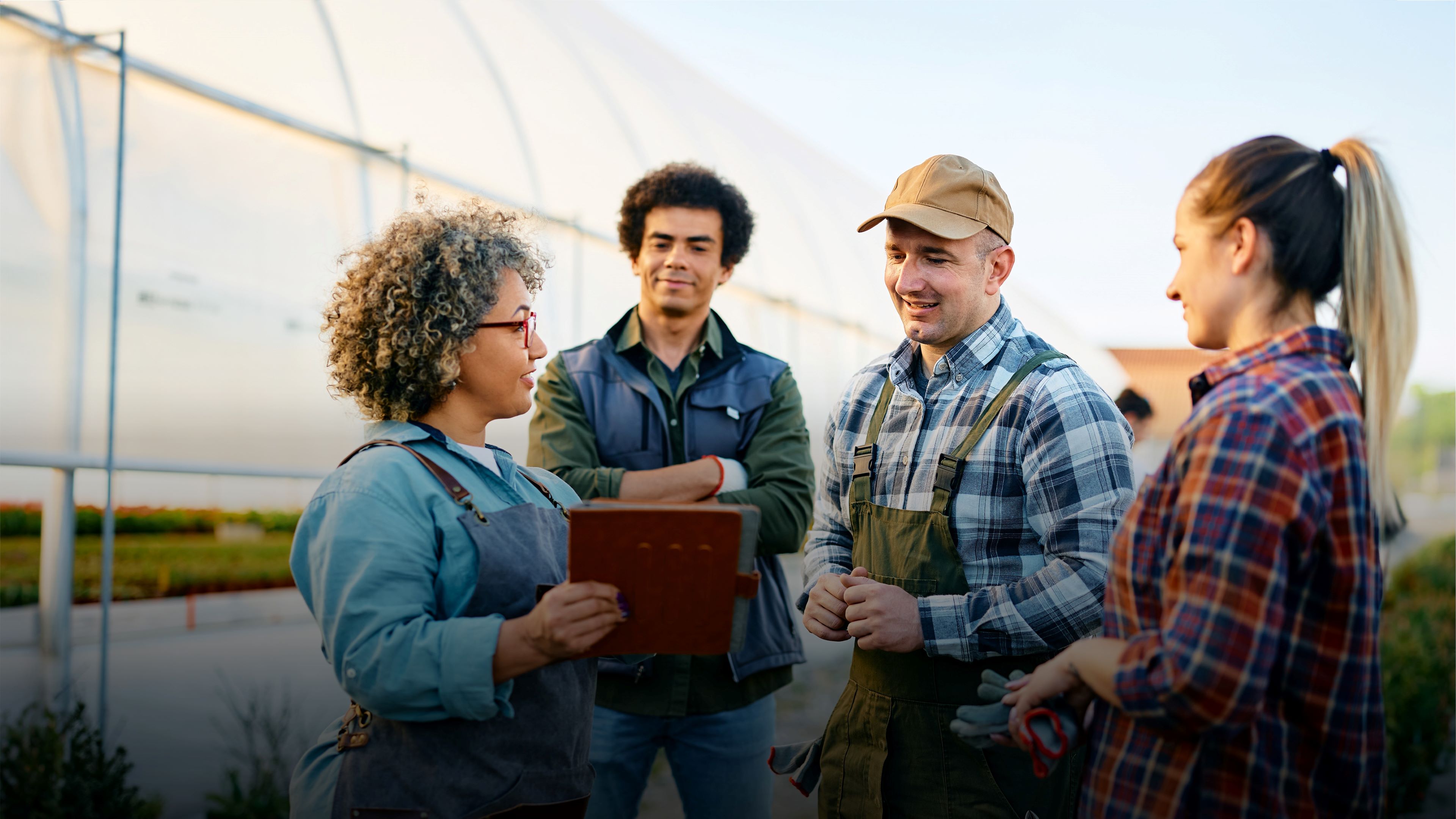 Image of three smallholder producers in a greenhouse